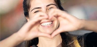 lady making a heart with her hands